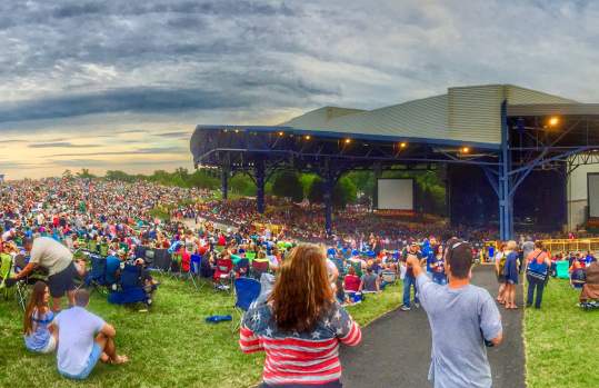 A group of people at an outdoor concert during the day