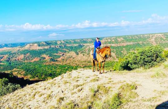 person on horseback on the edge of Palo Duro Canyon