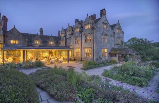 External view of Graveytye Manor and restaurant from the gardens, taken in the evening