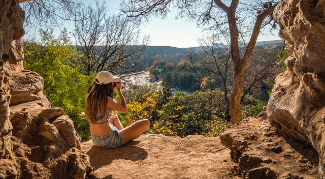 woman sitting on overlook at greenbelt in Austin Texas