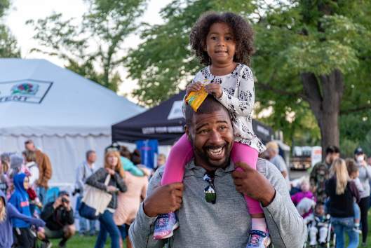 Girl Sitting on Man's Shoulders