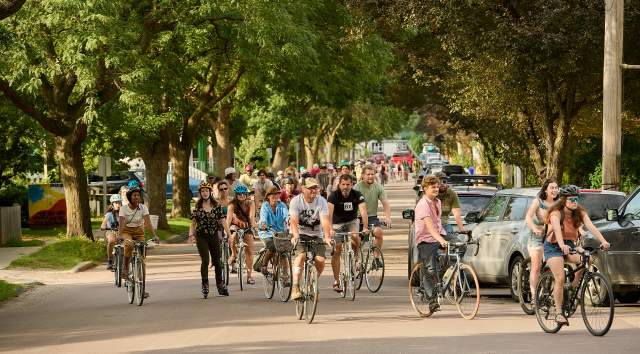 crowd of people on bikes in downtown Burlington