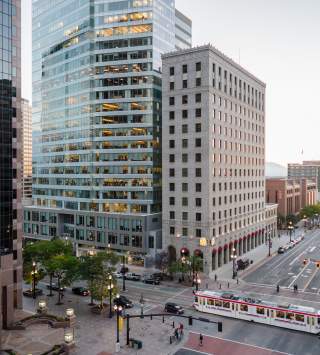 View of Salt Lake City main street with Trax light rail on the street and and early sunset sky