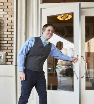 Staff opening the door to a Kimpton hotel