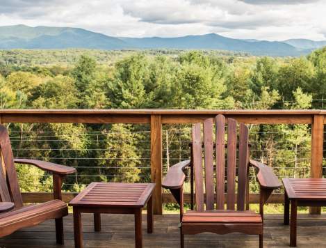 deck overlooking with chairs and table overlooking a forest