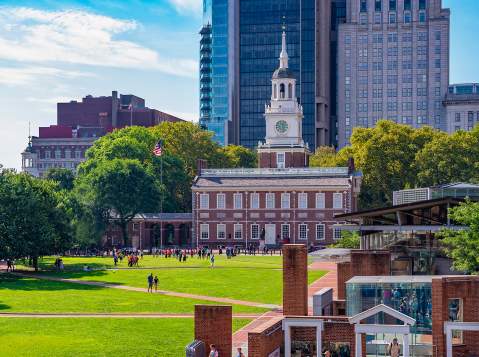 A large clock tower known as Independence Hall in Philadelphia on a sunny day