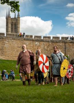 A group of people re-enacting historic battles and life