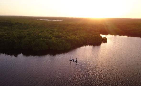 Aerial shot of Capt. Jay Withers fishing at sunset