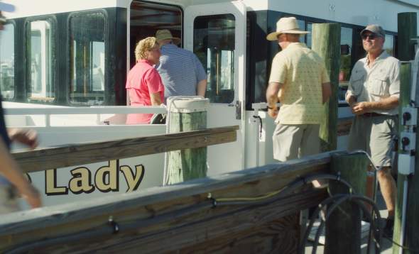 photo of Brenda Hillberry welcoming guests aboard Charlotte Lady/Kingfisher Fleet