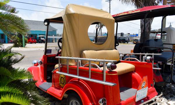 Back view of a golf cart designed to look like a vintage fire truck