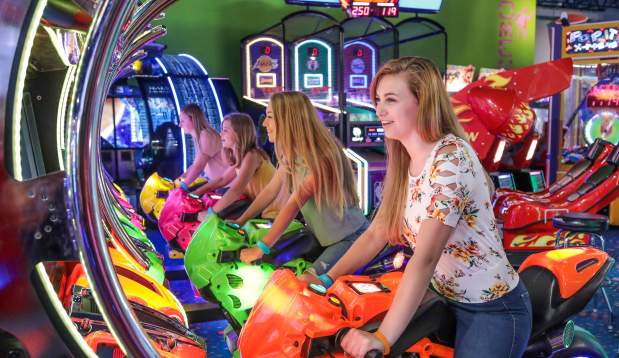 A group of young people enjoying Carlisle Sports Emporium's indoor arcade.