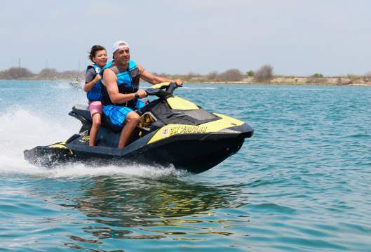 A dad and his kid jet skiing