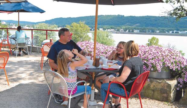 A family eats lunch at a local restaurant overlooking a river.