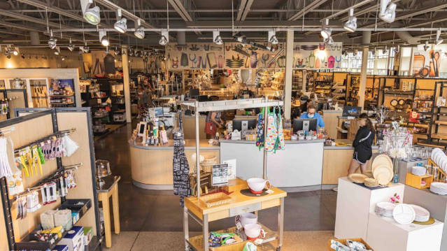 Interior of Boelter Superstore in Milwaukee, featuring wide aisles filled with kitchenware, cookware, and culinary tools, with shelves and display tables showcasing colorful bowls, utensils, and gift items.