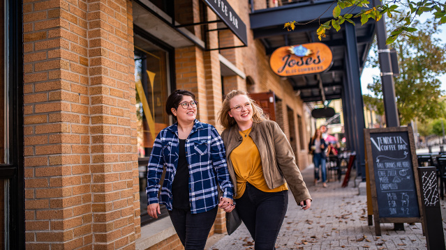 Couple happily walking Wauwatosa Street