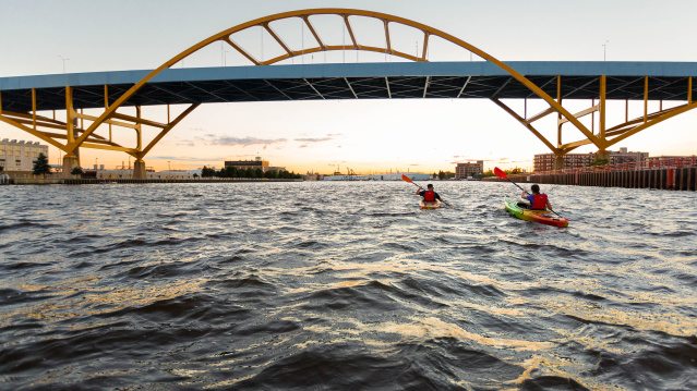 two kayakers kayaking under the Hoan Bridge
