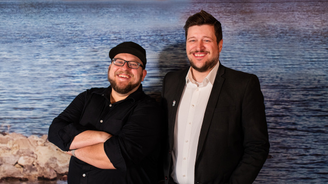 Two men smiling