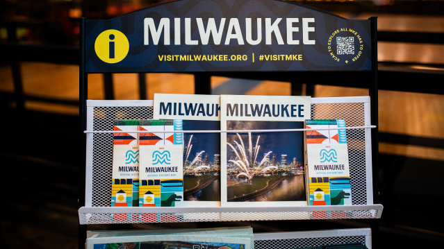 A display of Visit Milwaukee collateral including official visitors guides and maps.