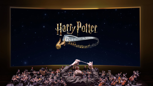 A symphony orchestra performs beneath a large screen displaying the logo for the Harry Potter Film Concert Series, featuring a conductor leading musicians in front of a starry night sky.