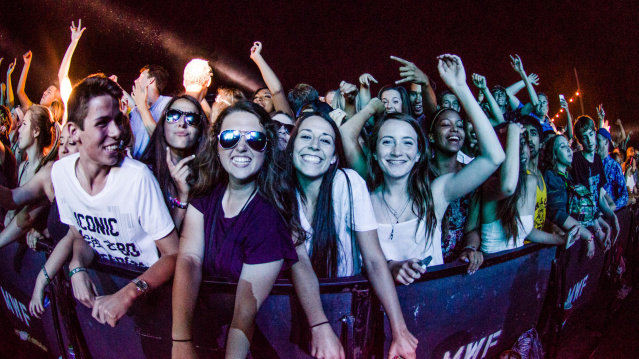A group of people at the front row of a music performance