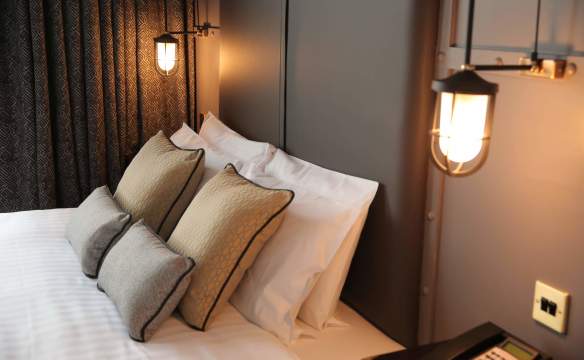 Modern, plush interior of a bedroom in the Titanic Hotel
