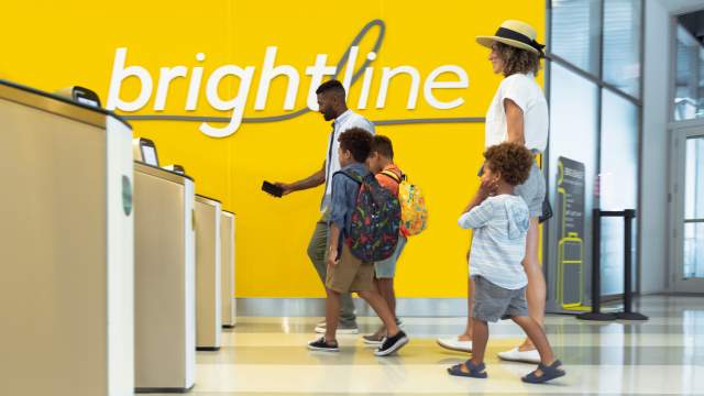 Family scanning tickets at Brightline station