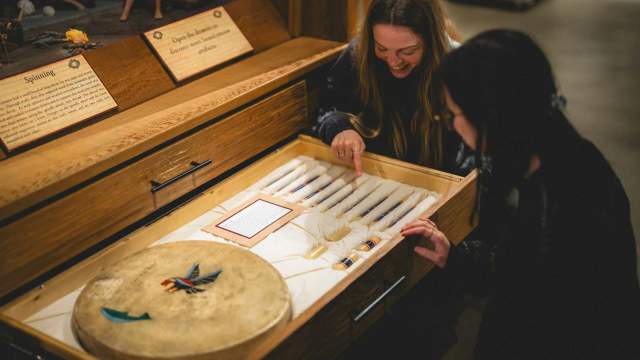 Two people looking at old tools.
