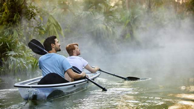 A gay couple kayaking through King's Landing at Wekiva River