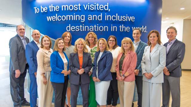 2026 Executive Leadership Team or Executive Management Team standing in the lobby of the Westwood suite
