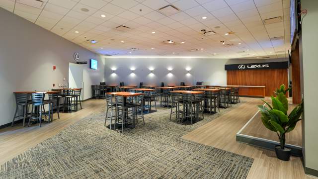 Lexus Club lounge with high top tables and a small stage