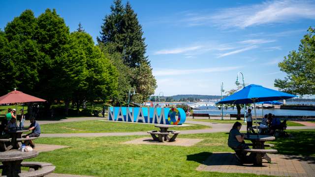 The Nanaimo sign and some tables in the sun.