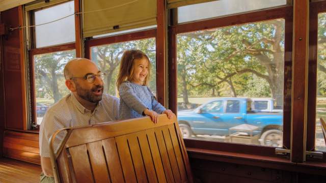 A father and daughter enjoying the St. Charles Avenue Streetcar together