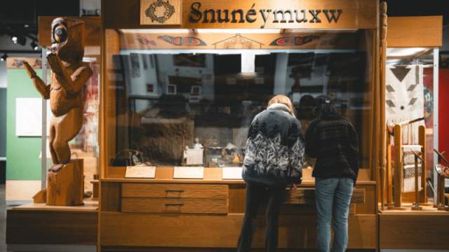 Two people looking at an exhibit in a museum.