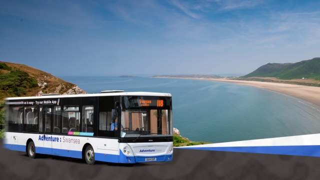 A picture of a bus with a Gower beach in the background.