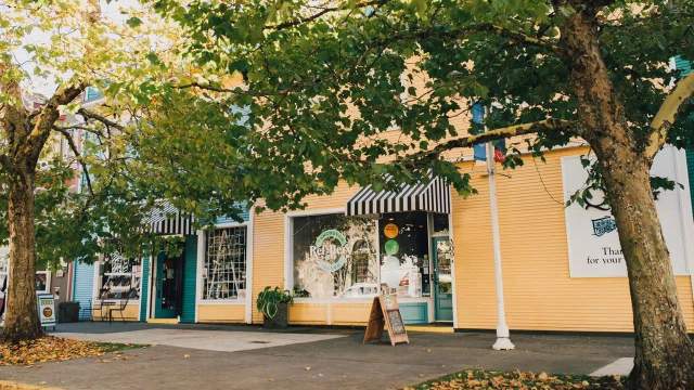 The outside of a row of little shops.