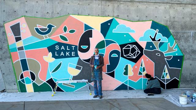 Traci O'Very Covey with her mural at Mountain America Expo Center
