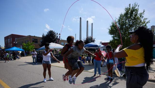 People jumping a rope in downtown Lansing during Juneteenth