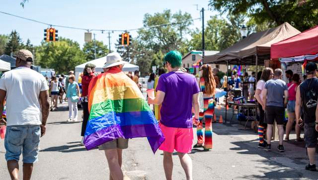 People walk through Old Town during Lansing Pride.