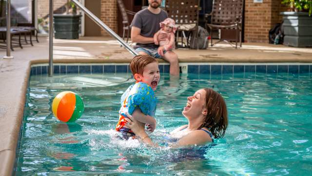 Mom and son playing in a pool