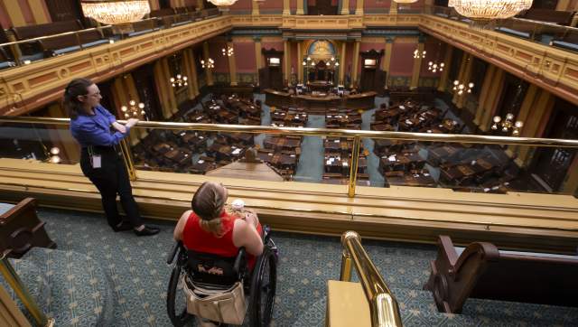 Wheelchair user and docent in the state capitol building