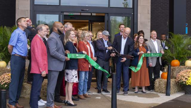Group of people cutting the ribbon to the new hotels