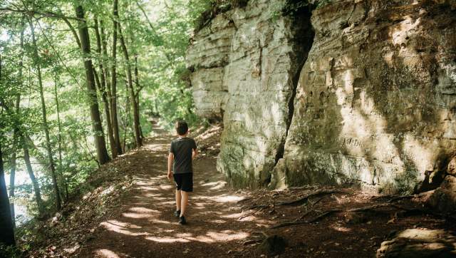 Young kid walking along the trail next to the Ledges at Fitzgerald Park