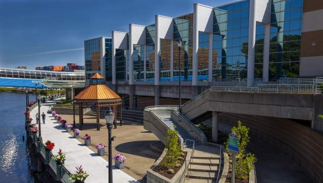 People walking on the Lansing River Trail by the outdoor space at the Lansing Center