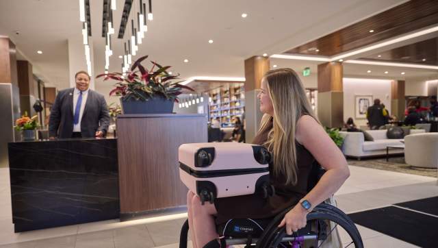 A wheelchair user with her luggage