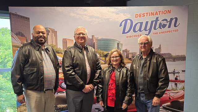 The Destination Dayton 2026 Community Ambassador Award winners standing in front of a Dayton-themed backdrop