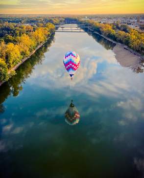 A hot air balloon hovering over the Wabash river in Terre Haute, Indiana