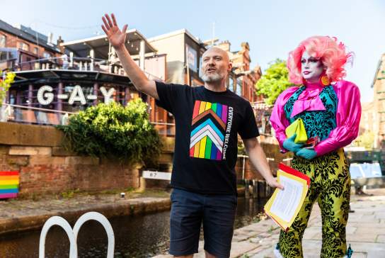 Tour guide on Manchester's Canal Street delivering LGBT tour of the city