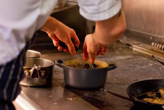 A chef at ABar Bistro in Portsmouth prepares a meal