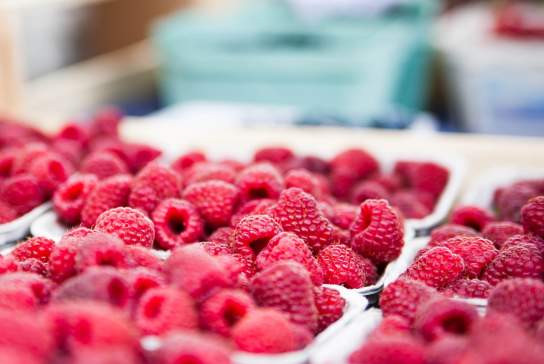 Photograph showing punnets of raspberries on sale at a market