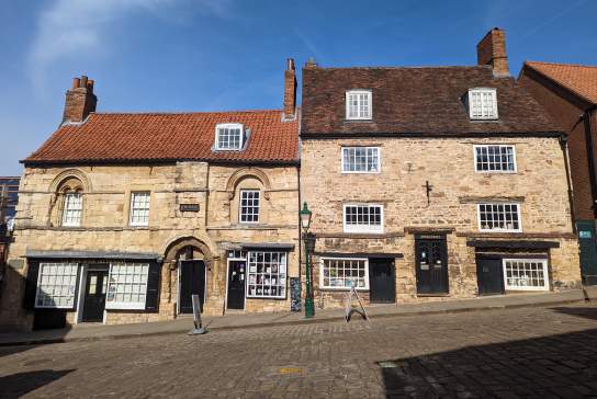 Exterior of Jew's House on Steep Hill in Lincoln with blue sky